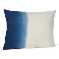 An ombre effect in inky blue enlivens this ivory wool pillow from DIANE von FURSTENBERG.