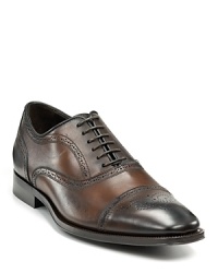 Sleek oxford with perforated upper and cap toe.