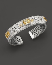 Sterling silver cuff set with faceted white sapphires and canary crystals. By Judith Ripka.