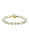 Elegance is a lustrous string of pearls. Majorica's bracelet of white organic man-made pearls (8 mm) features an 18k gold over sterling silver push-lock clasp. Approximate length: 7 inches.