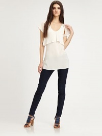 Sweetened by a front-to-back ruffle overlay, this pure silk scoopneck has cutout flutter sleeves and an enticing open back. ScoopneckShort, open flutter sleevesFront-to-back ruffle overlayOpen backLonger length hits below the hipsSilkDry cleanImportedModel shown is 5'10 (177cm) wearing US size Small. Sweetened by a front-to-back ruffle overlay, this pure silk scoopneck has cutout flutter sleeves and an enticing open back. ScoopneckShort, open flutter sleevesFront-to-back ruffle overlayOpen backLonger length hits below the hipsSilkDry cleanImportedModel shown is 5'10 (177cm) wearing US size Small.