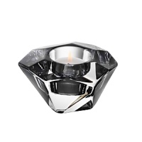 Shimmering facets and an asymmetrical design give this hand-cut, glistening crystal votive a shimmering, jewel-like look. Shimmering facets and an asymmetrical design give this hand-cut, glistening crystal votive a shimmering, jewel-like look.
