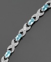 A unique setting for December's birthstone, this stylish bracelet by Victoria Townsend features oval-cut blue topaz (3 ct. t.w.) and diamond accents set in sterling silver. Approximate length: 7-1/4 inches.