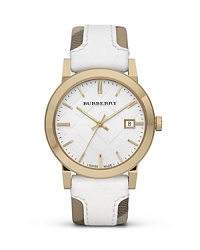 This Burberry watch makes an unforgettable impression. Crafted of gold-plated stainless steel with a bold, checked band, it models distinctive, designer style. This Burberry watch makes an unforgettable impression. Crafted of gold-plated stainless steel with a bold, checked band, it models distinctive, designer style.