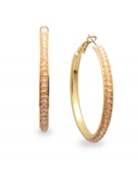 Party-perfect hoops. Add a flash of rich color to your look in c.A.K.e. by Ali Khan's sparkling champagne hoop earrings. Crafted in gold tone mixed metal with glass accents. Approximate diameter: 1-5/8 inches. Party-perfect hoops. Add a flash of rich color to your look in c.A.K.e. by Ali Khan's sparkling champagne hoop earrings. Crafted in gold tone mixed metal with glass accents. Approximate diameter: 1-5/8 inches.