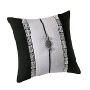 An elegant Chinoiserie-inspired decorative pillow in bold black and white, accented with a medallion and ribbon trim.