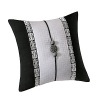An elegant Chinoiserie-inspired decorative pillow in bold black and white, accented with a medallion and ribbon trim.
