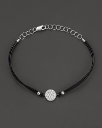 Diamonds, set in a circle of white gold, dazzle on a black leather bracelet. By Meira T. Diamonds, set in a circle of white gold, dazzle on a black leather bracelet. By Meira T.