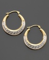 An age-old design symbolizing infinity and unity, the Greek key design looks decadent on these hoop earrings crafted in yellow and white 14k gold. Approximate diameter: 1/2 inch.