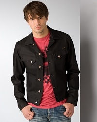Dry denim jacket with two buttoned pockets at chest. Tabs at waist for a better fit. Squiggly stitching on back yoke. Contrast orange stitching throughout. Dry denim jacket with two buttoned pockets at chest. Tabs at waist for a better fit. Squiggly stitching on back yoke. Contrast orange stitching throughout.