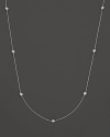 A white gold necklace with seven bezel-set diamond stations; with signature ruby accent. Designed by Roberto Coin.