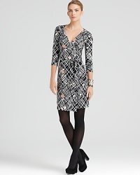 A modern black and white print, warmed with strategically-placed pops of color, enriches this timelesswrap-front DIANE von FURSTENBERG dress crafted from a silk jersey knit. A modern black and white print, warmed with strategically-placed pops of color, enriches this timelesswrap-front DIANE von FURSTENBERG dress crafted from a silk jersey knit.