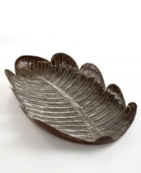 A product of their environment, this large leaf tray is handcrafted by Haitian artisans from recycled steel. Curved edges and intricate detail on its surface lend the one-of-a-kind piece to both use and display. A product of their environment, this large leaf tray is handcrafted by Haitian artisans from recycled steel. Curved edges and intricate detail on its surface lend the one-of-a-kind piece to both use and display.