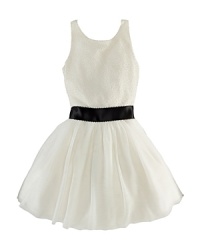 A quintessential party dress is intricately beaded for subtle sparkle and boasts a full silk tulle skirt and pretty satin sash to complete the festive look. A quintessential party dress is intricately beaded for subtle sparkle and boasts a full silk tulle skirt and pretty satin sash to complete the festive look.