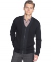 Suave and elegant. Look dashing in this fitted merino wool v-neck cardigan by Calvin Klein.