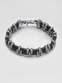 A modern look with textural detail crafted in a mix of leather wrapped with stippled sterling silver.LeatherSterling silverAbout 2½ diam.Imported A modern look with textural detail crafted in a mix of leather wrapped with stippled sterling silver.LeatherSterling silverAbout 2½ diam.Imported
