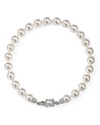 Simulated pearls set in rhodium-plated metal provide a luminous touch on this Nadri bracelet, laced with glistening cubic zirconia stones.