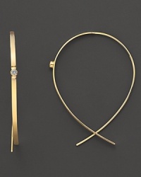 A single diamond gleams from the center of these wire-through 14K gold earrings. A single diamond gleams from the center of these wire-through 14K gold earrings.