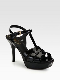 Patent leather t-strap has an adjustable slingback strap and ultra-high heel. Stacked heel, 4 (100mm)Stacked platform, 1 (25mm)Compares to a 3 heel (75mm)Patent leather upperLeather lining and solePadded insoleMade in Italy Patent leather t-strap has an adjustable slingback strap and ultra-high heel. Stacked heel, 4 (100mm)Stacked platform, 1 (25mm)Compares to a 3 heel (75mm)Patent leather upperLeather lining and solePadded insoleMade in Italy