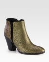 Trend-worthy silhouette of snake-embossed metallic leather with suede trim, a stacked heel and elastic side gores. Stacked heel, 3½ (90mm)Snake-embossed metallic leather upper with suede trim and side elastic goresSide zipLeather lining and solePadded insoleMade in Italy