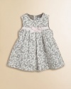 She can show her flower power in this corduroy favorite featuring a front grosgrain bow and mother-of-pearl adornment.Scoop neckBack button closureSleevelessFront and back pleatsKnee lengthFully linedCottonMachine washMade in France Please note: Number of buttons may vary depending on size ordered. 