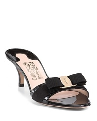 Ladylike patent leather slides with a signature Ferragamo logo plate and grosgrain ribbon at toe. Ladylike patent leather slides with a signature Ferragamo logo plate and grosgrain ribbon at toe.