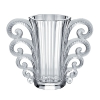 In 2010, to celebrate the 150th anniversary of René Lalique's birth in 1860, LALIQUE created the Hommage à René Lalique collection. In this collection, Lalique re-examines and reinterprets iconic glass creations of Rene Lalique. The Beauvais vase, created in 1931, is reissued in clear crystal. The manufacturing process truly requires the technical expertise of more than 10 glass masters. It is particularly difficult to shape the openwork crystal volutes and decorate both sides of the parison. To obtain the contrast of satin-finished and shiny crystal, characteristic of Lalique, the glass masters, as sculptors of light, detailed by hand each detail of the vase. The beauty of the artist-craftsman's motions serves his search for excellence. In 2010, to celebrate the 150th anniversary of René Lalique's birth in 1860, LALIQUE created the Hommage à René Lalique collection. In this collection, Lalique re-examines and reinterprets iconic glass creations of Rene Lalique. The Beauvais vase, created in 1931, is reissued in clear crystal. The manufacturing process truly requires the technical expertise of more than 10 glass masters. It is particularly difficult to shape the openwork crystal volutes and decorate both sides of the parison. To obtain the contrast of satin-finished and shiny crystal, characteristic of Lalique, the glass masters, as sculptors of light, detailed by hand each detail of the vase. The beauty of the artist-craftsman's motions serves his search for excellence.