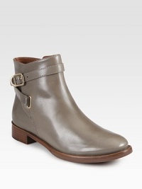 Smooth leather ankle boot with a stacked heel and rubber sole for traction, wrapped by an adjustable buckle strap. Stacked heel, 1 (25mm)Leather upperLeather liningRubber solePadded insoleImportedOUR FIT MODEL RECOMMENDS ordering true size. Smooth leather ankle boot with a stacked heel and rubber sole for traction, wrapped by an adjustable buckle strap. Stacked heel, 1 (25mm)Leather upperLeather liningRubber solePadded insoleImportedOUR FIT MODEL RECOMMENDS ordering true size.