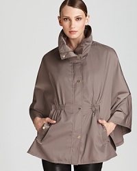 Complete your rainy day look with Calvin Klein's captivating cape, boasting a funnel collar with practical zip-out hood and flattering cinched waist. Complete your rainy day look with Calvin Klein's captivating cape, boasting a funnel collar with practical zip-out hood and flattering cinched waist.