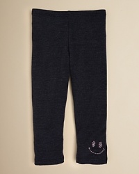 A sequin smiley face adorns the left leg of Sofi's comfy cotton leggings. A sequin smiley face adorns the left leg of Sofi's comfy cotton leggings.