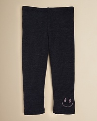 A sequin smiley face adorns the left leg of Sofi's comfy cotton leggings.