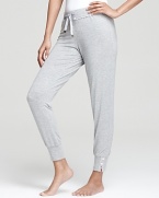 Lounge around in style and comfort. Juicy Couture's slim pants in soft fabric with lace detail.