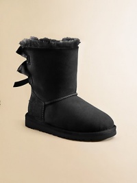 A feminine design with ribbon bows lining the back for sweet style. Pull-on style Sheepskin upper Molded EVA sole Padded insole Sheepskin lining Imported A feminine design with ribbon bows lining the back for sweet style. Pull-on style Sheepskin upper Molded EVA sole Padded insole Sheepskin lining Imported