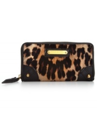 Get your glam on with this luxe leopard print wallet from Juicy Couture that speaks sass and seduction. The exterior is dressed in plush velour, soft leather trim and shiny golden hardware, while plenty of slots and compartments organize the inside.