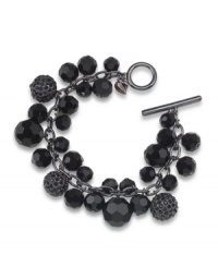 Sophisticated style. Black glass beads with glittering charms have an elegant effect on Carolee's cluster bracelet. Crafted in hematite tone mixed metal with a toggle closure, it's an effortless choice for mixing and matching within your wardrobe. Approximate length: 8 inches.