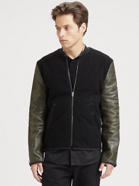 An edgy approach to a prepster favorite, an iconic varsity jacket is rendered in wool fleece with contrasting leather sleeves and pairs easily with your casual wardrobe staples.Zip frontRibbed knit collarWaist slash pocketsAbout 26 from shoulder to hem70% wool/25% nylon/5% cashmereDry cleanImported