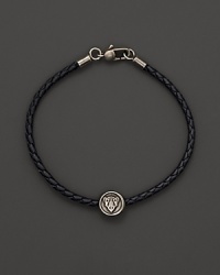 Silver Gucci charm on a braided black natural leather bracelet.