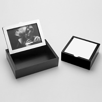 This wooden box contains a removable top with Christofle Silver on one side and a picture frame on the other side. A wonderful way to show off your favorite picture while giving you a little box to store your favorite mementos. Silver-plate and wood.