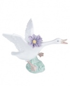 Taking flight with big purple blossoms in tow, this leaping duck captures the grace of nature in lustrous Lladro porcelain.