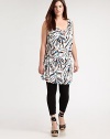 A festive print meets a design offering classic, draped details. This will be a figure-flattering tunic that you will love to wear with skinny jeans or leggings. Draped necklineSleevelessAllover printSelf-tie detail at backPull-on style About 37 from shoulder to hem94% venezia/6% spandexDry cleanMade in USA