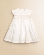 This design featuring beautiful rosebuds and elegant pleating is the perfect dress for your little one. Round necklineRuffled cap sleevesRosebuds with scalloped trimBack button closurePima cottonMachine washImported