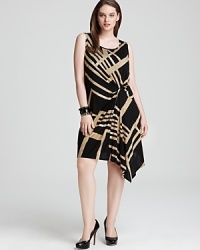 Capitalizing on this season's tribal trend, this DKNYC Plus dress sends your style on a wild ride with an oversized graphic print and a gathered asymmetric skirt. Capitalizing on this season's tribal trend, this DKNYC Plus dress sends your style on a wild ride with an oversized graphic print and a gathered asymmetric skirt.