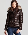 In an ultra soft, satin nylon, this plush and pillowy Moncler coat with fur hood is a luxe investment for winter.