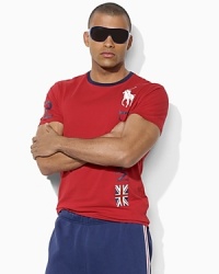 Rendered in ultra-soft cotton jersey, a trim-fitting crewneck T-shirt is accented with bold country graphics, celebrating Team USA's participation in the 2012 Olympic Games. Rendered in ultra-soft cotton jersey, a trim-fitting crewneck T-shirt is accented with bold country graphics, celebrating Team USA's participation in the 2012 Olympic Games.