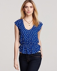 Feminine details like polka dots and a ruffled hem lend serious charm to this ALTERNATIVE top. Feminine details like polka dots and a ruffled hem lend serious charm to this ALTERNATIVE top.