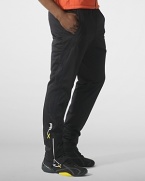 Designed for high-level comfort and superior performance, an athletic track pant is crafted in sleek stretch microfiber with hydro-mesh panels and reflective graphics.