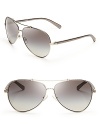 Fly to new style heights in these stylish Tory Burch aviator sunglasses.