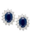 Regale yourself with something regal. Victoria Townsend's royalty-inspired stud earrings feature oval-cut sapphires (3 ct. t.w.) encircled by round-cut white topaz (1-1/10 ct. t.w.). Set in 18k gold over sterling silver. Approximate diameter: 1/2 inch.