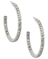 Cover every angle in sparkle. Givenchy's elegant hoop earrings flaunt an inside out design crystallized with Swarovski elements. Crafted in imitation rhodium plated mixed metal. Approximate diameter: 1-1/8 inches.