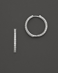 Inside/outside diamond hoop earrings; with signature ruby accent. Post closure for pierced ears. Designed by Roberto Coin. Inside/outside diamond hoop earrings; with signature ruby accent. Post closure for pierced ears. Designed by Roberto Coin.
